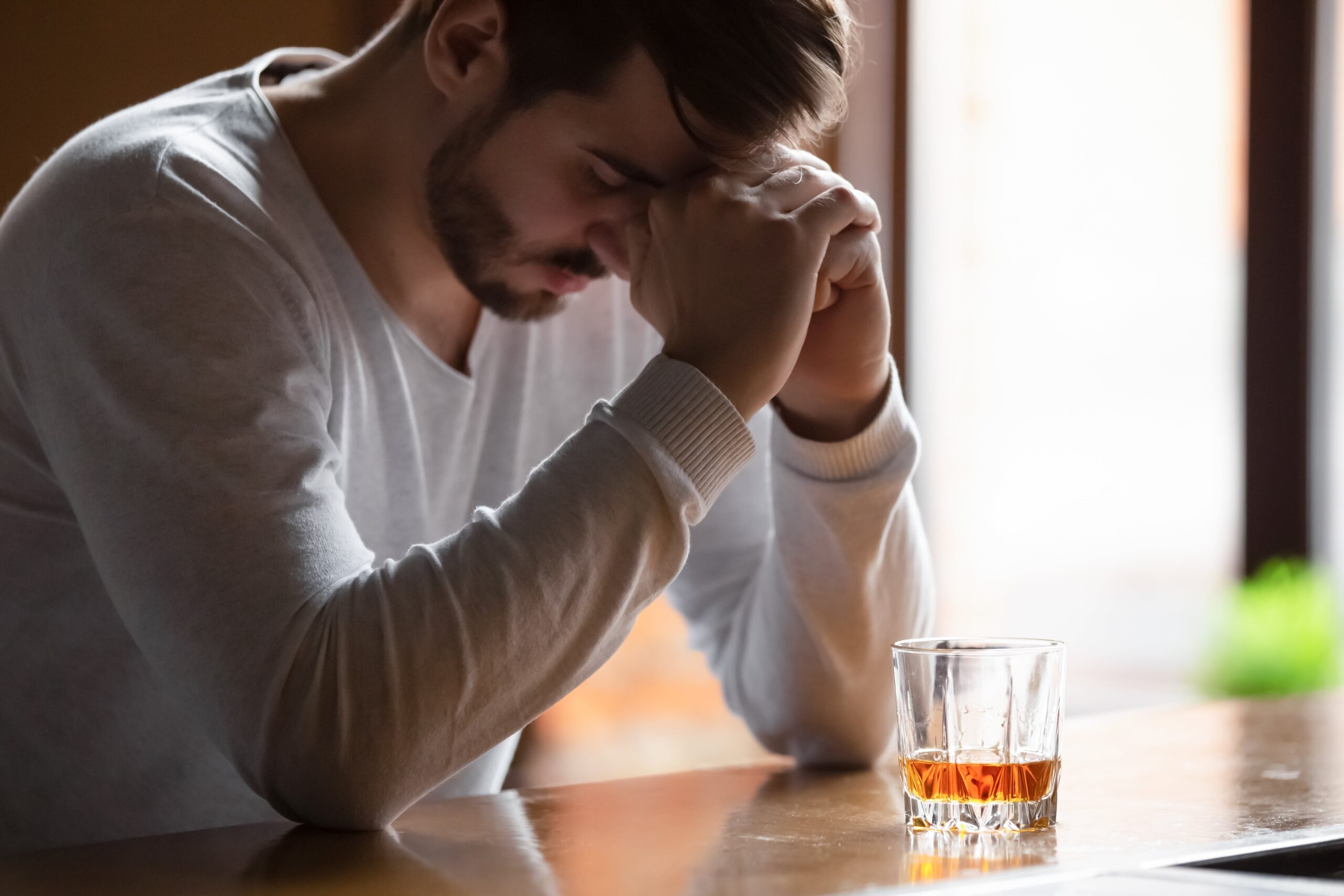 man struggling with withdrawal symptoms during Dry January